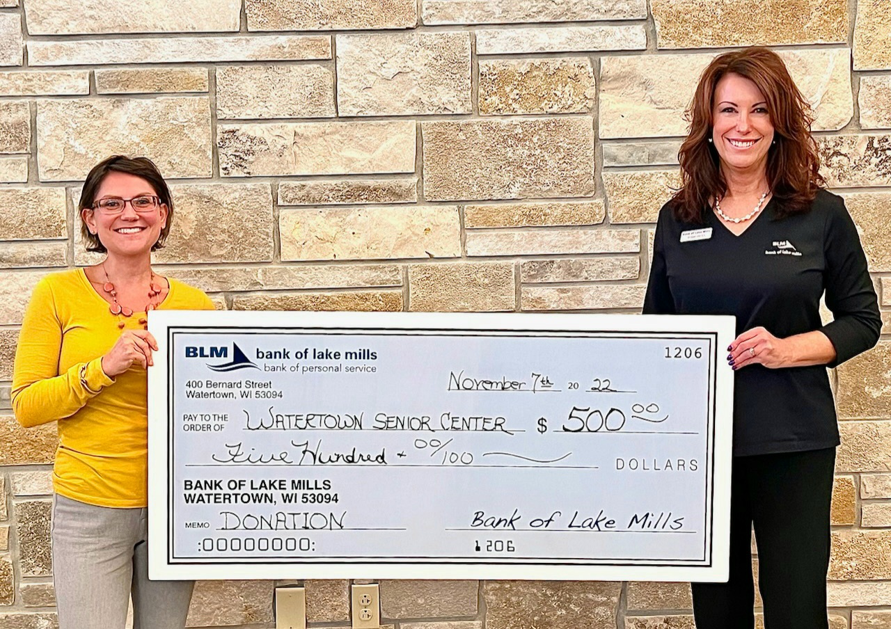 two women holding a check